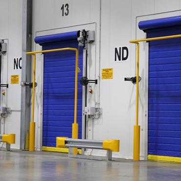 Blue and yellow high speed roll up doors.